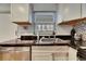 Modern kitchen with sink, granite countertops, and white cabinets at 4250 37Th S St # 5, St Petersburg, FL 33711