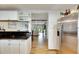 Kitchen with stainless steel refrigerator and view into living area at 4250 37Th S St # 5, St Petersburg, FL 33711