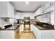 Updated kitchen featuring white cabinets, stainless steel appliances, and wood-look flooring at 4250 37Th S St # 5, St Petersburg, FL 33711