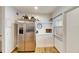 Stainless steel refrigerator in kitchen with white cabinets and wood flooring at 4250 37Th S St # 5, St Petersburg, FL 33711