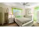 Bright bedroom featuring a white bed frame and matching dresser at 4345 Union Springs Rd, Spring Hill, FL 34608