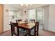 Casual dining area with a wooden table and access to the kitchen and outside at 4345 Union Springs Rd, Spring Hill, FL 34608