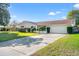 Single-story house with driveway, landscaped lawn, and attached garage at 4345 Union Springs Rd, Spring Hill, FL 34608