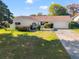 Bright exterior view of a single-story house with a large yard at 4345 Union Springs Rd, Spring Hill, FL 34608