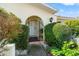 Front entrance with wrought iron gate and well-manicured landscaping at 4345 Union Springs Rd, Spring Hill, FL 34608
