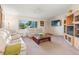 Spacious living room featuring light-colored furniture and a built-in cabinet at 4345 Union Springs Rd, Spring Hill, FL 34608