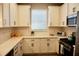 Well-equipped kitchen featuring white cabinets and stainless steel appliances at 5426 Rushmere Ct, Palmetto, FL 34221