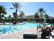 Community pool with lounge chairs and patio tables at 5426 Rushmere Ct, Palmetto, FL 34221