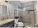 Clean bathroom with updated vanity, toilet, and a shower with glass enclosure at 5715 20Th W St, Bradenton, FL 34207