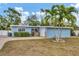 Cute light blue house with palm trees and a spacious yard at 5715 20Th W St, Bradenton, FL 34207