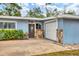 Light blue house featuring a stone accent wall and attached garage at 5715 20Th W St, Bradenton, FL 34207