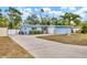 Charming light blue house with a well-maintained lawn and driveway at 5715 20Th W St, Bradenton, FL 34207
