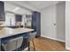 Modern kitchen with dark blue cabinets, stainless steel appliances, and an island at 5715 20Th W St, Bradenton, FL 34207