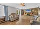 Bright living room with hardwood floors, stone fireplace, and French doors leading to the backyard at 5715 20Th W St, Bradenton, FL 34207