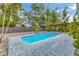 Inviting pool area with brick pavers, pergola, and lush landscaping at 5715 20Th W St, Bradenton, FL 34207