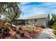 Landscaped backyard with mature plants and screened patio at 6233 Florida E Cir, Apollo Beach, FL 33572