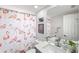 Charming bathroom with flamingo shower curtain and gray vanity at 6233 Florida E Cir, Apollo Beach, FL 33572
