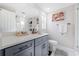 Updated bathroom with gray vanity, quartz countertop, and walk-in shower at 6233 Florida E Cir, Apollo Beach, FL 33572