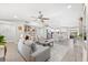 Open concept living area with gray sofas and kitchen view at 6233 Florida E Cir, Apollo Beach, FL 33572