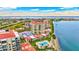 Gorgeous aerial view of waterfront condominiums with red tile roofs and shimmering pool overlooking the bay at 6322 Palma Del Mar S Blvd # 209, St Petersburg, FL 33715