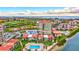 Aerial view of complex with pool, lush landscaping and nearby bay and golf course at 6322 Palma Del Mar S Blvd # 209, St Petersburg, FL 33715