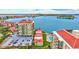 Aerial view of the complex showing the buildings, pool, parking, and bay at 6322 Palma Del Mar S Blvd # 209, St Petersburg, FL 33715