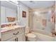 Cozy bathroom with framed mirror, vanity, toilet, and shower with glass doors at 6322 Palma Del Mar S Blvd # 209, St Petersburg, FL 33715