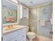 Bathroom with a vanity, mirror, decorative wallpaper, and a glass-enclosed shower at 6322 Palma Del Mar S Blvd # 209, St Petersburg, FL 33715