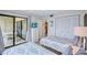 Bright bedroom featuring twin beds, access to balcony, and a view of the outside, creating a relaxing and inviting space at 6322 Palma Del Mar S Blvd # 209, St Petersburg, FL 33715