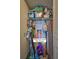 A functional utility closet with shelving, washer/dryer hookups, and storage for cleaning supplies, maximizing space in the home at 6322 Palma Del Mar S Blvd # 209, St Petersburg, FL 33715