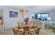 Inviting dining area with a glass-top table, rattan chairs, and a view of the ocean at 6322 Palma Del Mar S Blvd # 209, St Petersburg, FL 33715