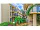 View of the building's exterior showing stairs, landscaping, and walkway at 6322 Palma Del Mar S Blvd # 209, St Petersburg, FL 33715