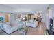 Cozy living room with two white sofas, a glass coffee table, and tile flooring at 6322 Palma Del Mar S Blvd # 209, St Petersburg, FL 33715