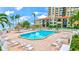 Beautiful pool area with lounge chairs, tiki umbrellas, and views of the bay at 6322 Palma Del Mar S Blvd # 209, St Petersburg, FL 33715