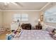 Bedroom with a light purple comforter, plenty of stuffed animals, and a desk at 6388 21St N Ave, St Petersburg, FL 33710