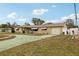 House exterior showcasing a spacious yard and attached garage at 6388 21St N Ave, St Petersburg, FL 33710