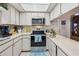 Modern kitchen with stainless steel appliances and white cabinetry at 6388 21St N Ave, St Petersburg, FL 33710