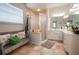 Bathroom with walk-in shower, bench and updated vanity at 6769 Greenview Ln, Englewood, FL 34224