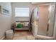Spa-like bathroom featuring a walk-in shower and a built-in bench at 6769 Greenview Ln, Englewood, FL 34224