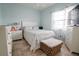 Bright bedroom with a queen-size bed and tile floors at 6769 Greenview Ln, Englewood, FL 34224