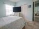 Bedroom with a queen bed, large TV, and ample closet space at 6769 Greenview Ln, Englewood, FL 34224