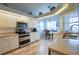 Kitchen with stainless steel appliances and granite countertops at 6769 Greenview Ln, Englewood, FL 34224