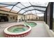 Spa and pool area with screened lanai at 6769 Greenview Ln, Englewood, FL 34224