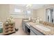 Double vanity bathroom with granite countertops and a large shower at 7401 Paradiso Dr, Apollo Beach, FL 33572