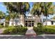 Community clubhouse entrance with landscaping and palm trees at 7401 Paradiso Dr, Apollo Beach, FL 33572
