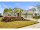 Two-story house with landscaping and a two-car garage at 7401 Paradiso Dr, Apollo Beach, FL 33572