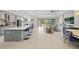 Open kitchen with island, stainless steel appliances, and breakfast bar at 7401 Paradiso Dr, Apollo Beach, FL 33572