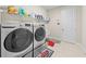 Laundry room with washer, dryer, and overhead shelving at 7401 Paradiso Dr, Apollo Beach, FL 33572