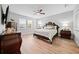 Spacious main bedroom with wood floors and en-suite bath at 7401 Paradiso Dr, Apollo Beach, FL 33572