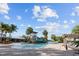 Community pool; waterslide, lounge chairs, palm trees at 7401 Paradiso Dr, Apollo Beach, FL 33572